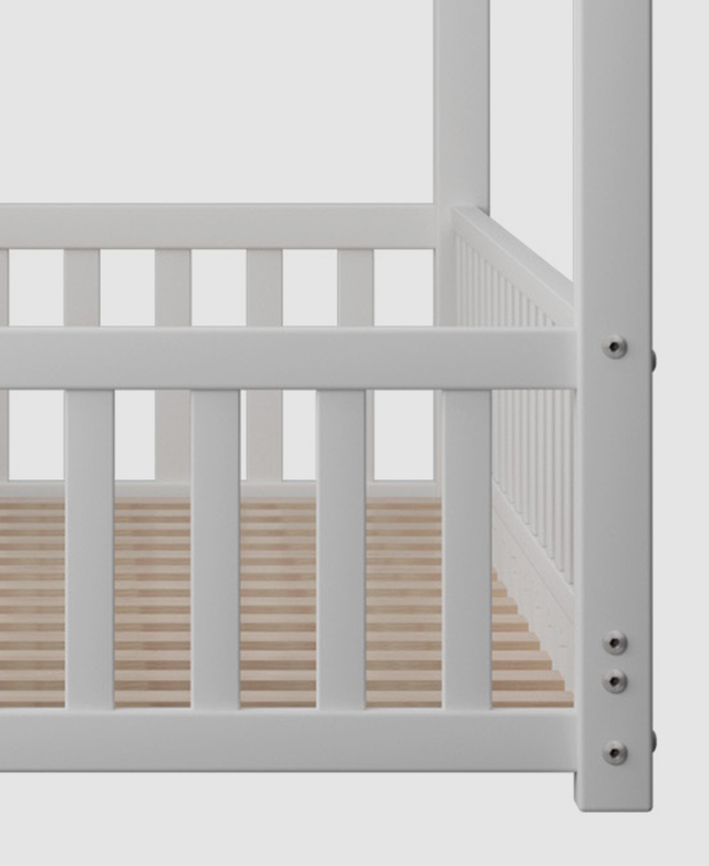 The slatted guard rails are captured to show the security around the bed.
