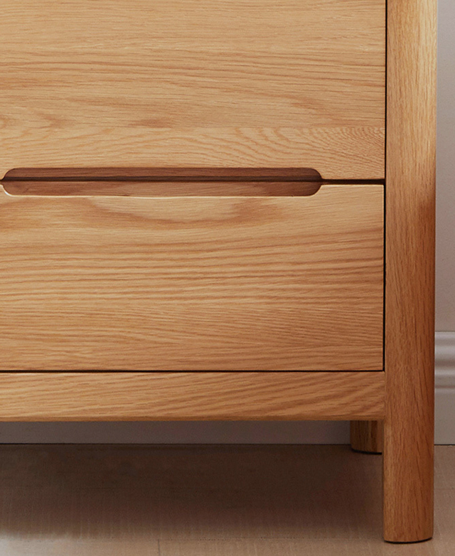 Close up and front on, the neat shape and recessed drawer handles are central.