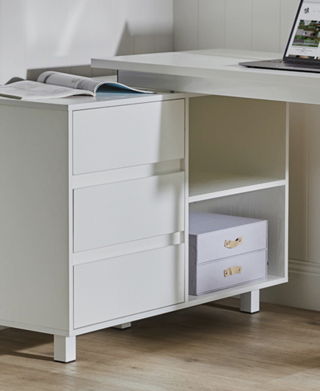 Directly below an end of the table top, its storage facilities include three drawers and two open shelves. Directly below an end of the table top, its storage facilities include three drawers and two open shelves.