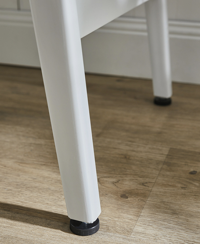 On one side of the table, two iron legs connected by a centre bar provide support underneath the MDF top. On one side of the table, two iron legs connected by a centre bar provide support underneath the MDF top.
