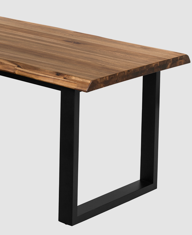 A sleigh leg in a black painted finish is shown underneath the timber top.