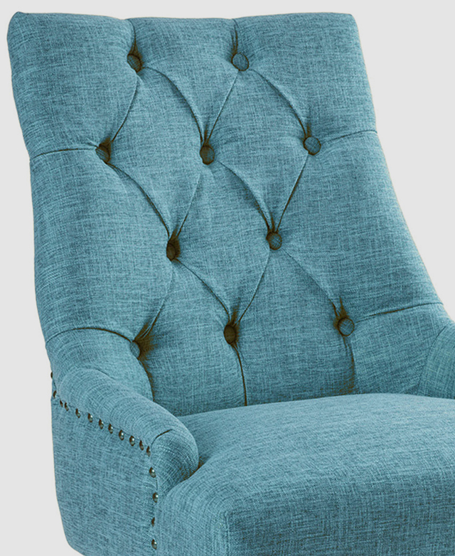The tall backrest features traditional tufting and pleat details. Low armrests wrap around the seat cushion. The tall backrest features traditional tufting and pleat details. Low armrests wrap around the seat cushion.