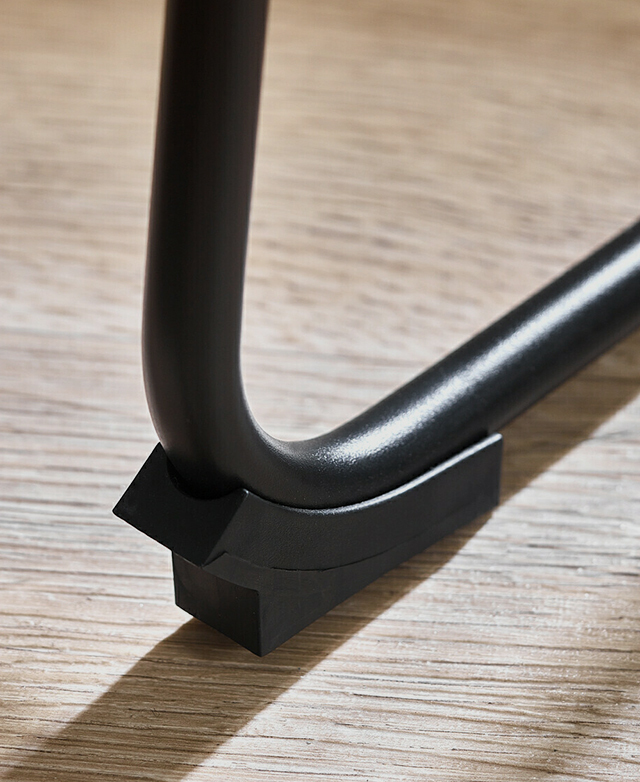 Zoomed-in view of the black steel ski leg with a protective floor cap at the tip. Zoomed-in view of the black steel ski leg with a protective floor cap at the tip.