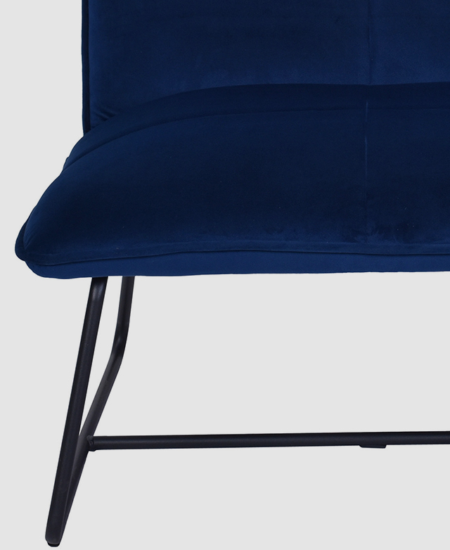 A steel black powder-coated sleigh leg base with plastic foot protectors underneath a navy velvet chair. A steel black powder-coated sleigh leg base with plastic foot protectors underneath a navy velvet chair.
