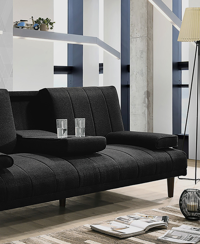 A linen sofa with dark grey upholstery in a living room setting. Two glasses sit in the centre console cup holders.