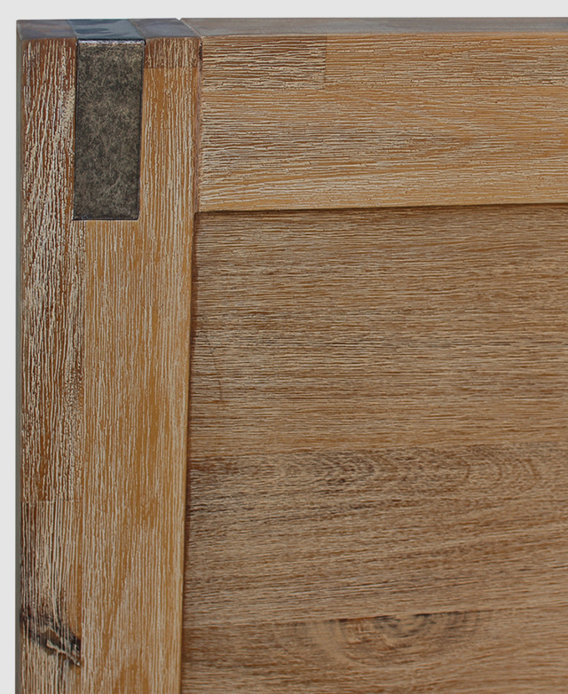 The top corner of the bedhead outlines the metal accent and the vintage finish of the wood. The top corner of the bedhead outlines the metal accent and the vintage finish of the wood.