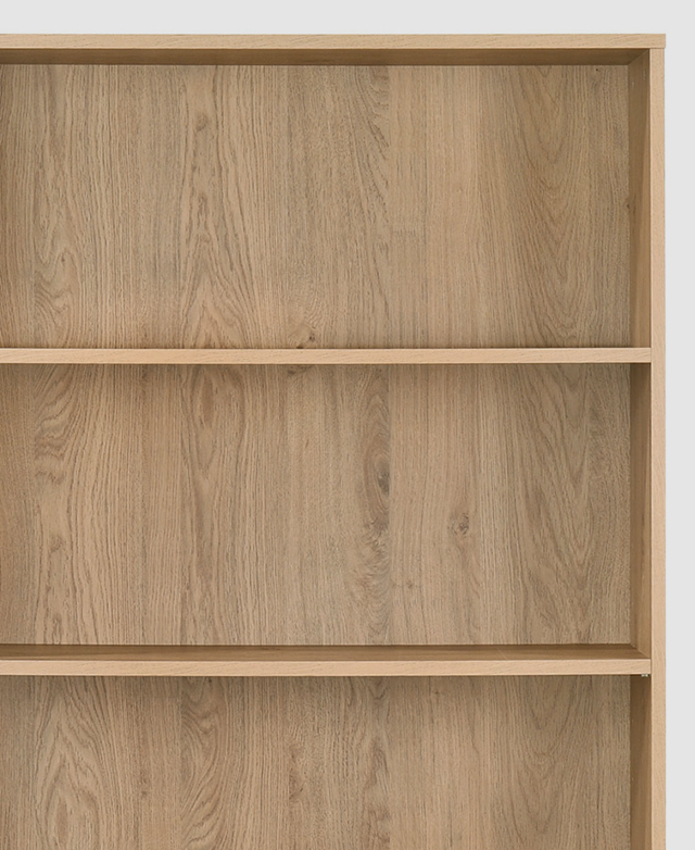A corner of a timber bookcase with shelves.