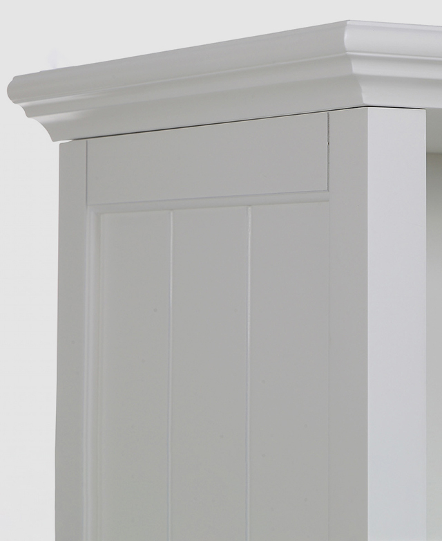 The top of a white bookcase with a recessed bevelled edge and panelled sides.