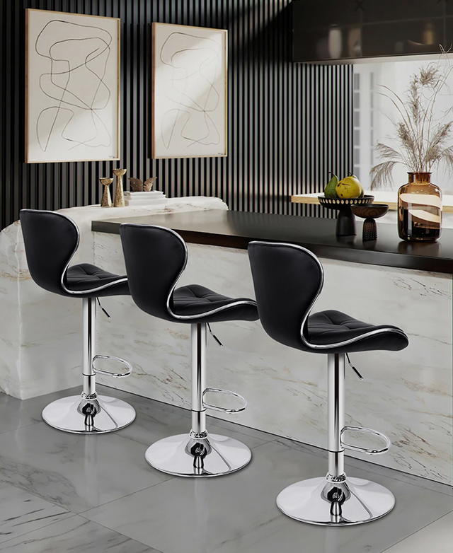 Three black bar stools with backs are styled in a contemporary dining space, positioned at a marble kitchen island. Three black bar stools with backs are styled in a contemporary dining space, positioned at a marble kitchen island.