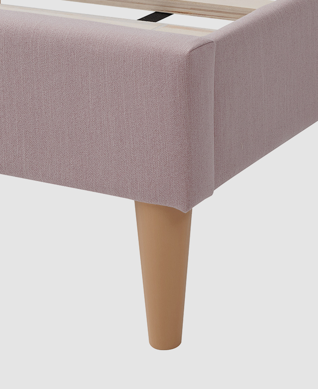 Large-scale view of a tapered leg underneath the bed. It has a light blonde timber-look finish.