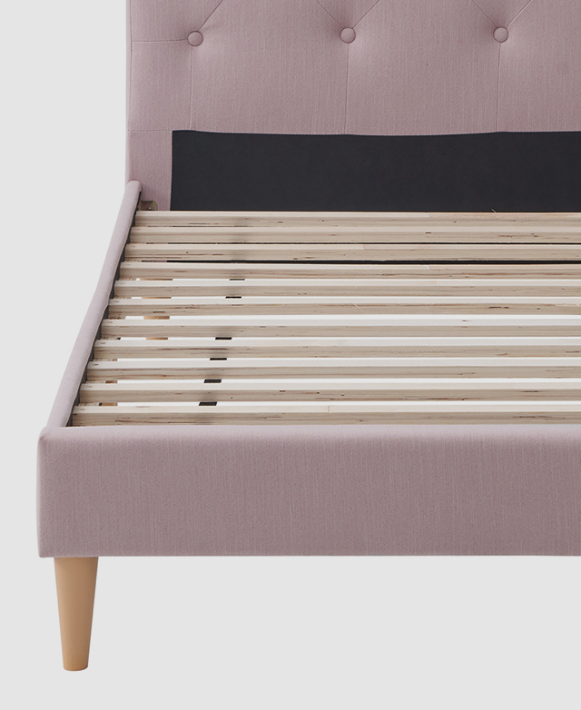 The interior base of the bed frame features wooden slats that are evenly spaced apart.