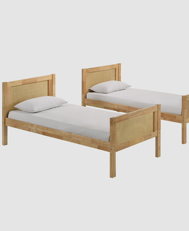 Two single beds with a timber frame and rattan panels at either end.