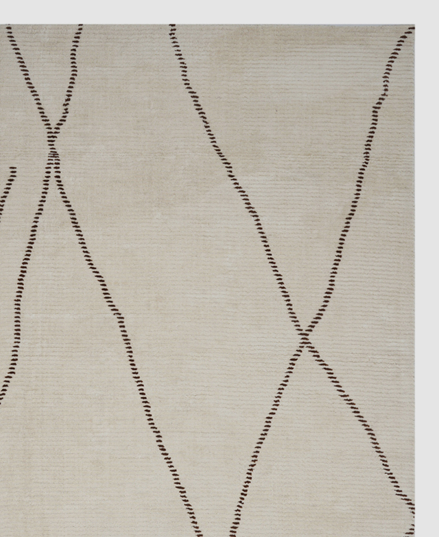 Bird's-eye view of a cream-coloured rug with contrasting dark brown linework.