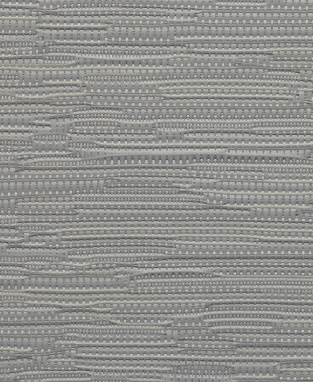 Close up of the texture of the thick, woven fabric of a light grey polyester roller blind.