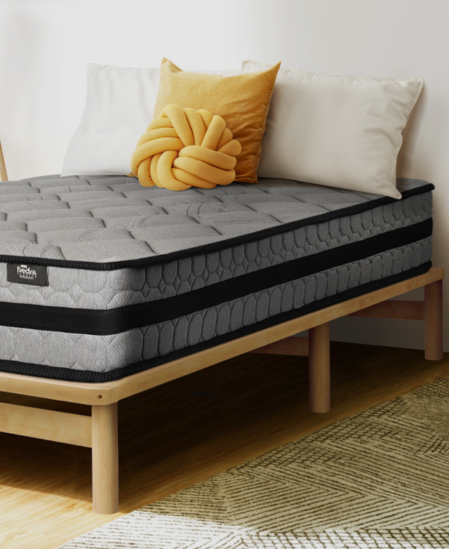 The foot of the bed base is shown from an angle. A supportive centre beam runs between the two end cylindrical legs.