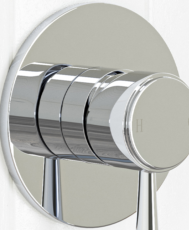 Traditional shower wall mixer in chrome mounted on a white tile wall