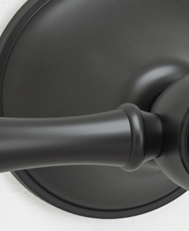 Traditional matte black lever wall tap assembly close up showing the surface composition Traditional matte black lever wall tap assembly close up showing the surface composition