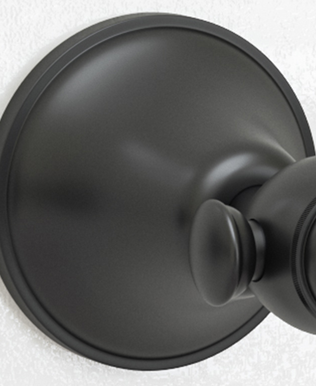 Traditional matte black lever wall tap assembly close up showing the spindles Traditional matte black lever wall tap assembly close up showing the spindles