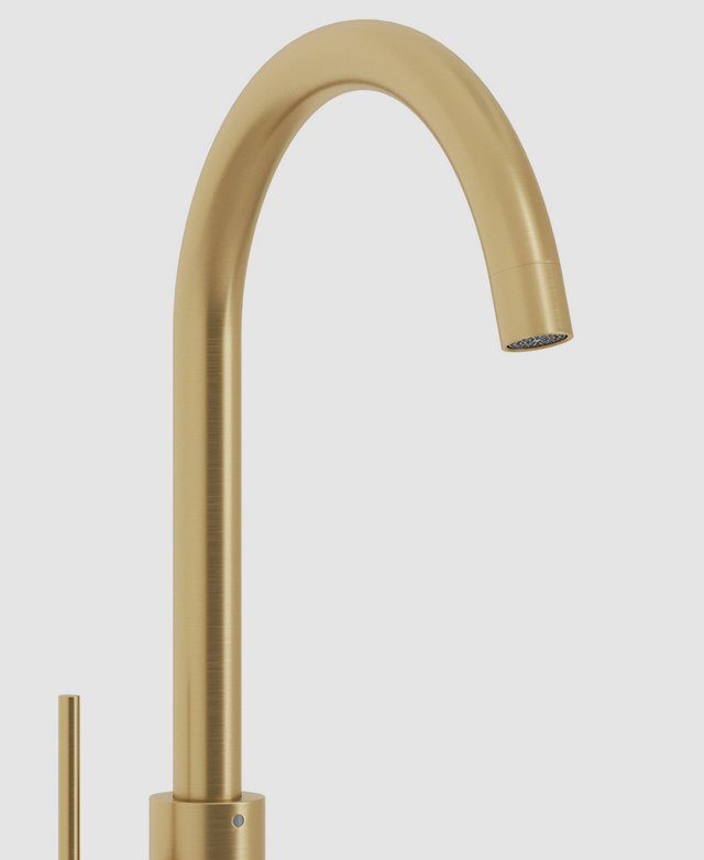 Close-up of the gooseneck and spout from the clovelly brushed gold kitchen sink mixer against a white background