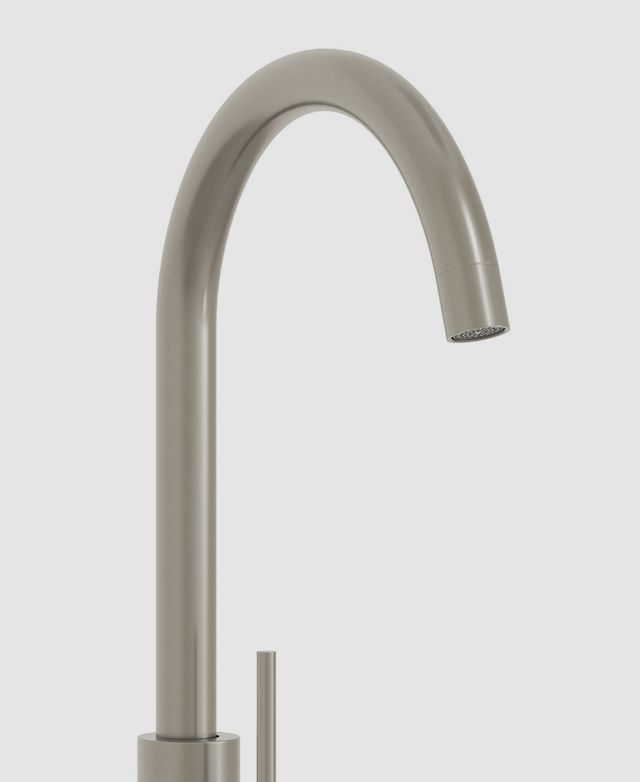 Close-up of the gooseneck and spout from the clovelly brushed nickel kitchen sink mixer against a white background. Close-up of the gooseneck and spout from the clovelly brushed nickel kitchen sink mixer against a white background.