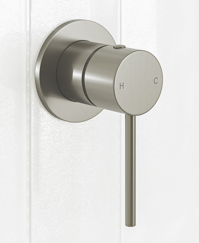 Brushed nickel shower/bath wall mixer mounted on a white tiled wall