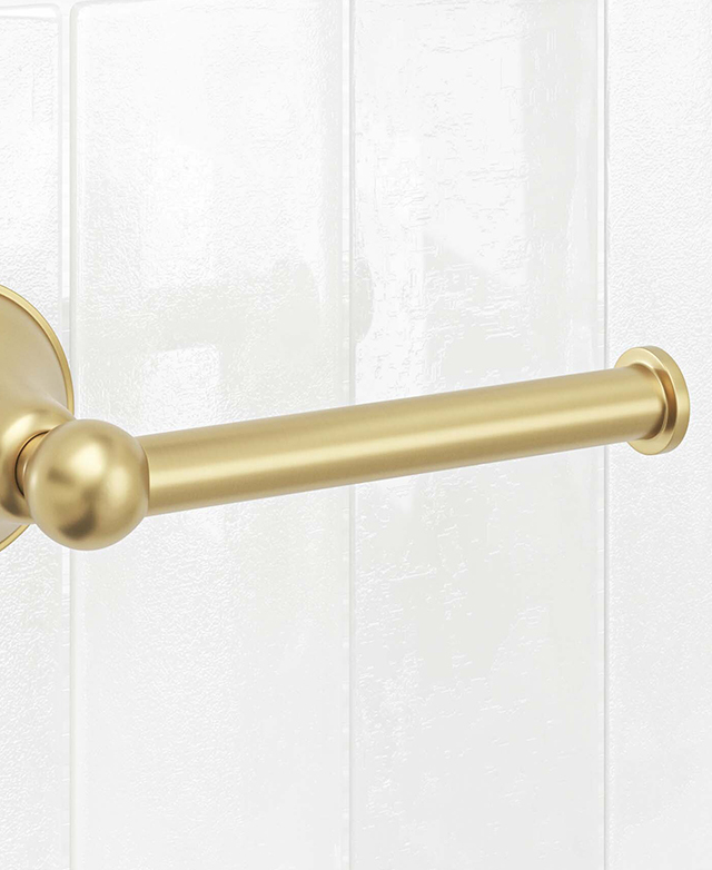 Close-up of stanwell brushed gold toilet roll holder mounted on a white tiled wall