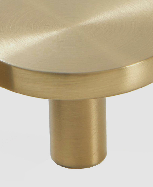 In-depth close-up of the brushed gold cabinet knob against a white background