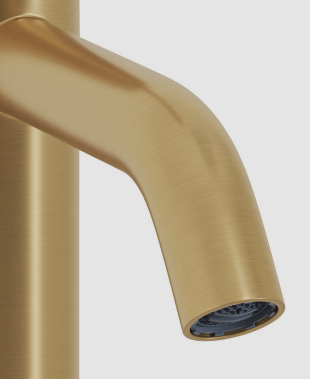 Close-up of the clovelly round brushed gold spout and part of base on a white background