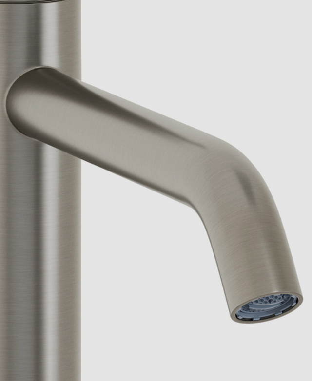 Close-up the clovelly brushed nickel round spout and part of the body of the mixer