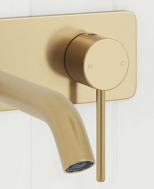 Close-up of the clovelly brushed gold round spout, mixer with pin lever and rectangular backplate