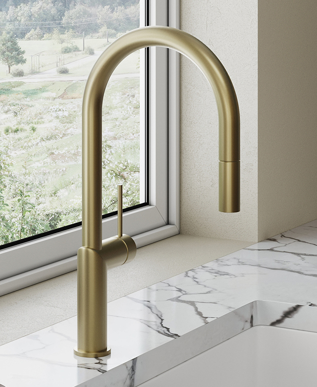 Clovelly brushed gold kitchen sink mixer mounted on marble benchtop in front of the kitchen window.