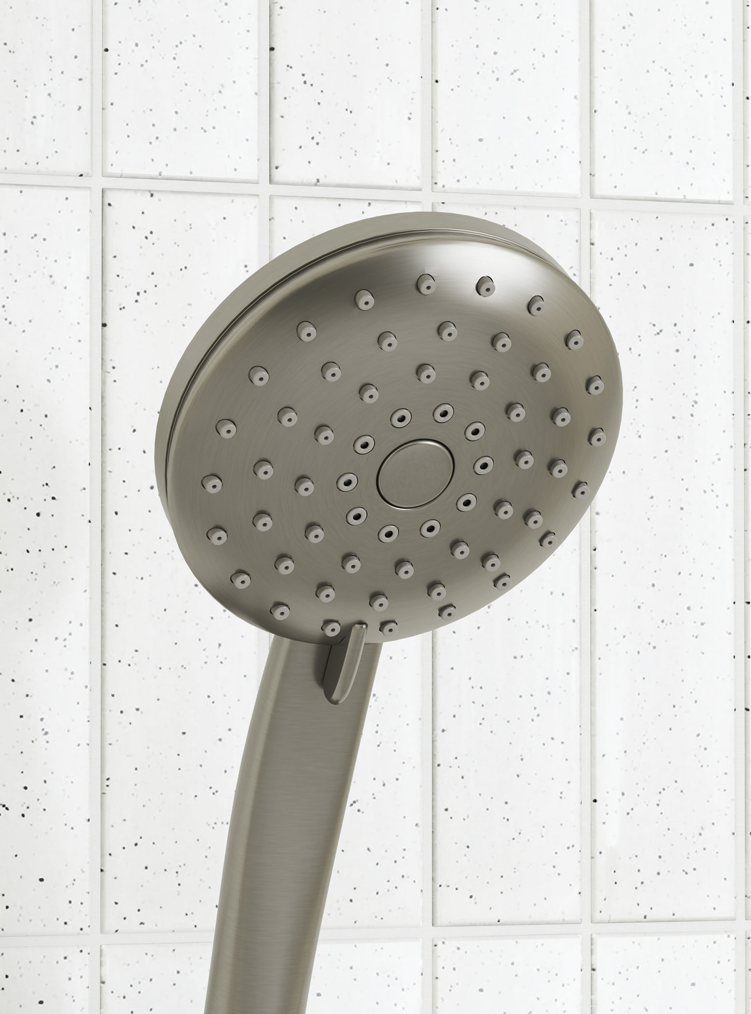 Round brushed nickel shower hand piece close up of shower nozzle pattern and the lever for water pattern selecting