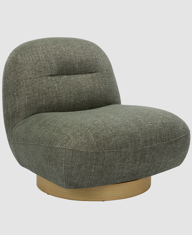Green accent chair on a white background displayed at an angle to showcase its soft edges and curves. Green accent chair on a white background displayed at an angle to showcase its soft edges and curves.