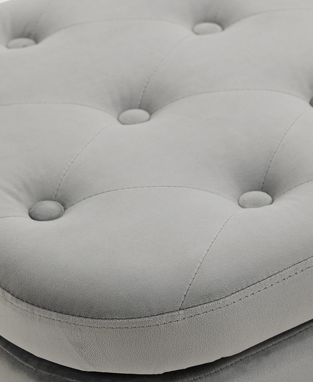 Button tufting a piping trims adorn the top of the green velvet ottoman.
