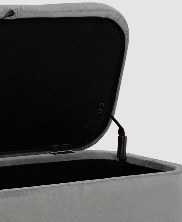The lid is lifted on hinges of the yellow ottoman.