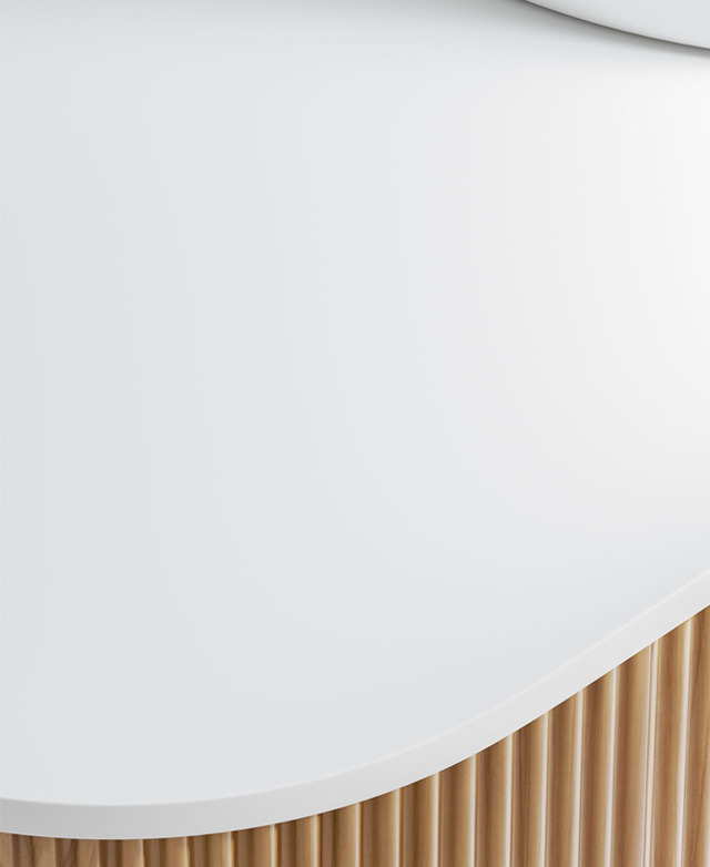 The smooth edge of the white sintered stone top is in focus, with the groove-front cabinet just shown. The smooth edge of the white sintered stone top is in focus, with the groove-front cabinet just shown.