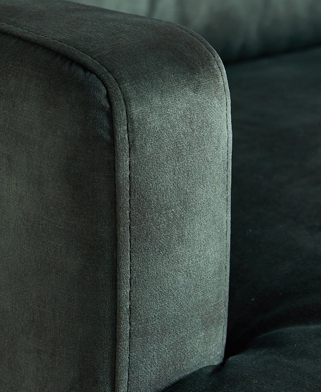 Close view of an armchair highlights the softness and subtle sheen of the velvet upholstery. Close view of an armchair highlights the softness and subtle sheen of the velvet upholstery.