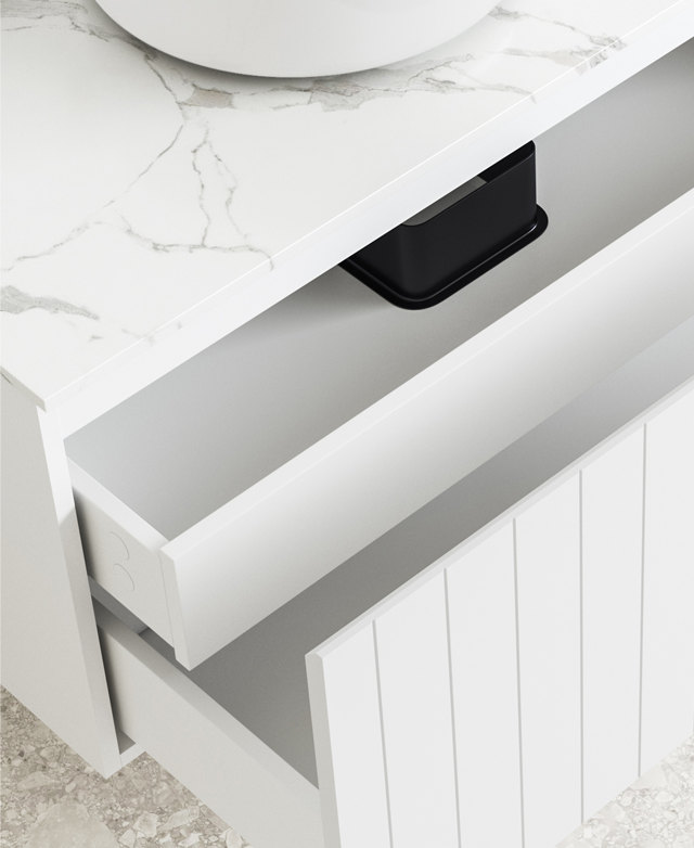 The drawers are shown open, with the focus on the shallow inner drawer. Grey veining of the white stone top is just shown. The drawers are shown open, with the focus on the shallow inner drawer. Grey veining of the white stone top is just shown.