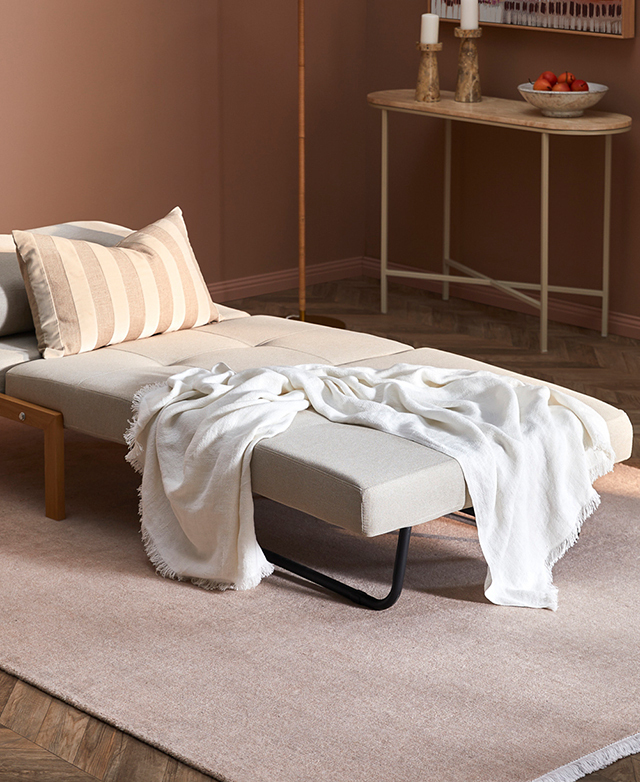 The sofa is converted to a bed formation, illustrating its clean look and neat single size.