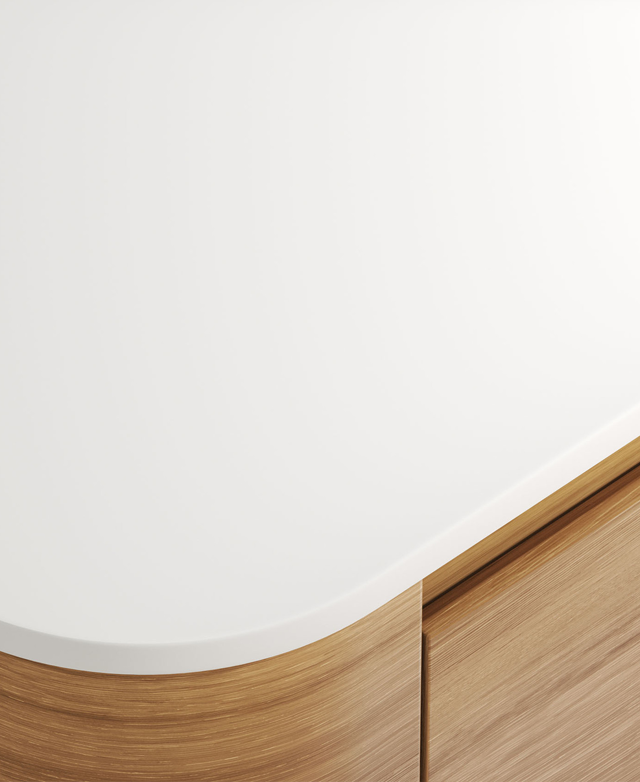 Highlighted is the crisp white sintered stone top and its curved corner; the oak-coloured base is just in the frame.