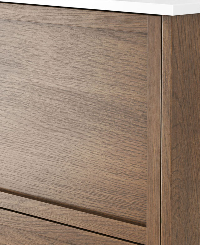 Close-up of a modern timber cabinet with handleless drawers, wood grain and white top.