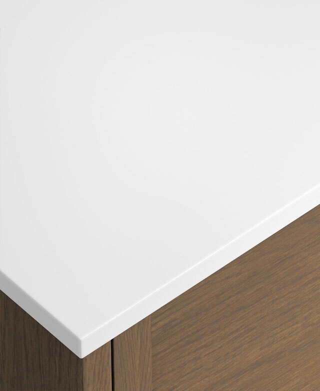 White top with rounded edge on light timber cabinet, showing clean, modern corner detail.