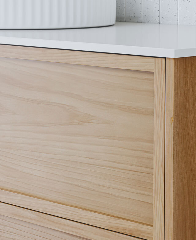 Close-up of a modern timber cabinet with handleless drawers, wood grain and white top.