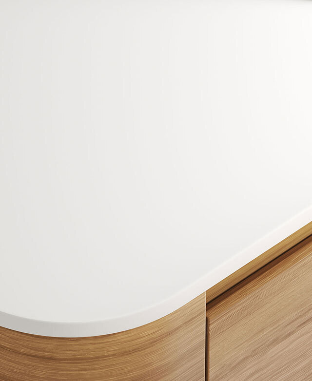 Highlighted is the crisp white sintered stone top and its rounded corner; the oak-coloured base is just in the frame.