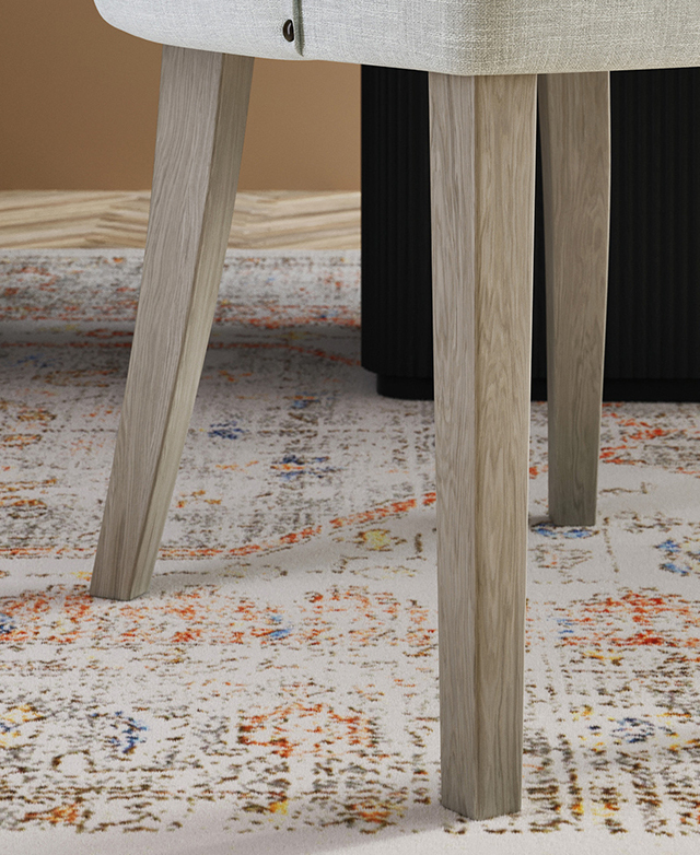 Close-up of solid rubberwood legs underneath a chair. The rectangular shape is gently tapered.