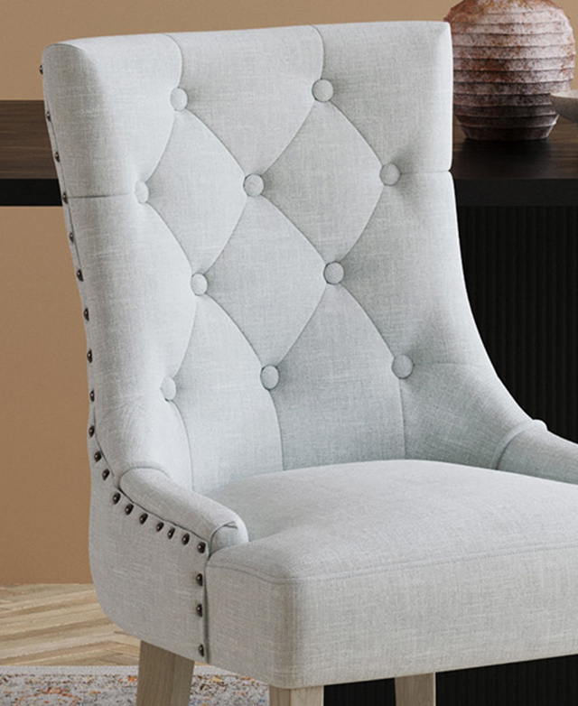 Close up on the diamond button tufting and the metal stud trim.