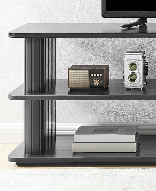 Cropped view shows one end of the cream TV unit filled with decor and topped with a TV.