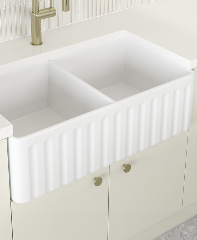 White double fireclay ceramic sink showing the ribbed surface facing the front. White double fireclay ceramic sink showing the ribbed surface facing the front.