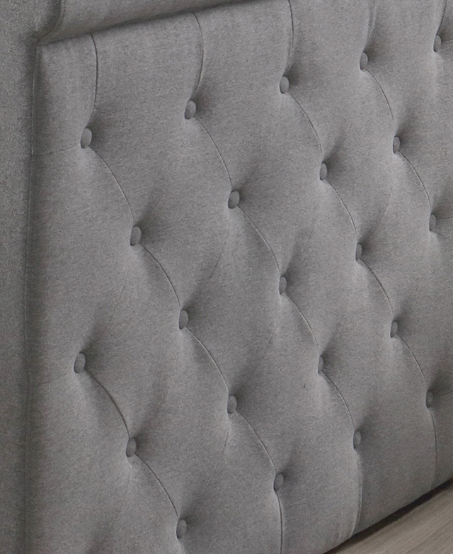 Close-up of the diamond button-tufted detail on the 100% polyester upholstery of the sofa bed. Close-up of the diamond button-tufted detail on the 100% polyester upholstery of the sofa bed.