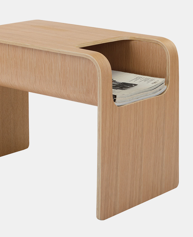 Placed horizontally, with curved top edges and a cut-out section that holds flat magazines.